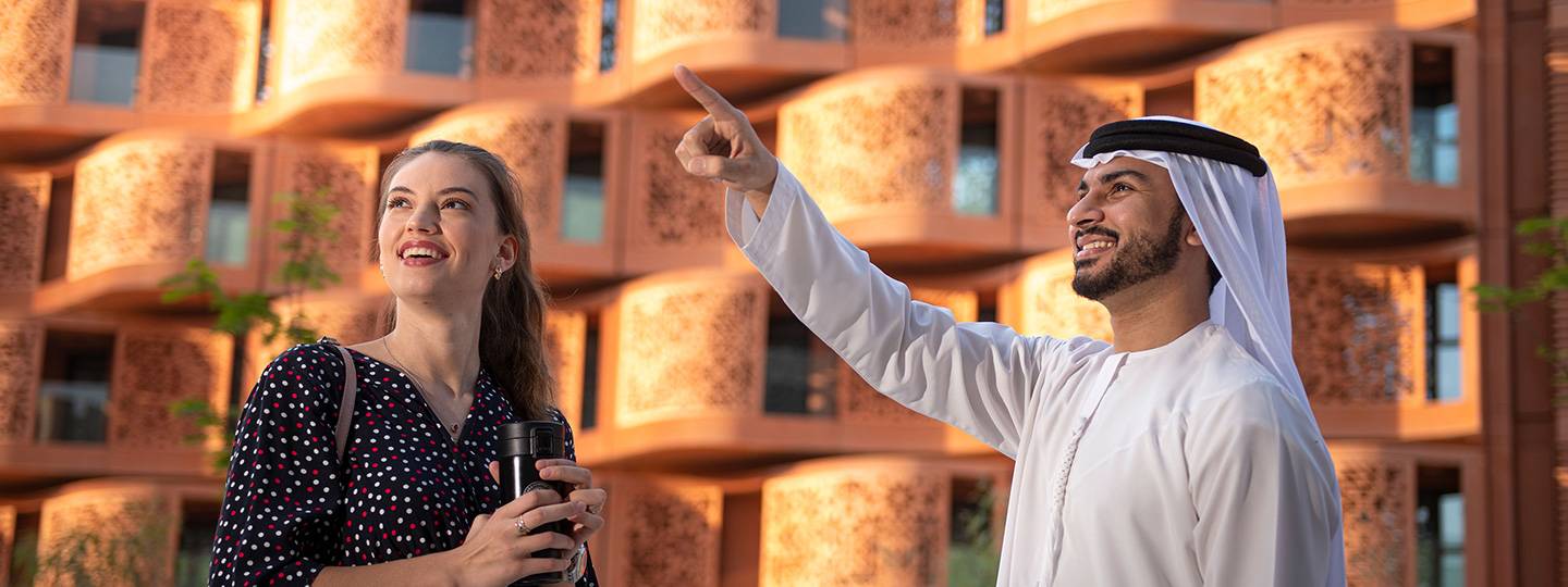 Sheikh showing scenic view to a woman of Masdar City Free Zone